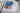 Auf einem Sofa liegt ein zusammengeklapptes CEWE FOTOBUCH. Das Cover zeigt weiße Häuser Griechenlands und einen Olivenzweig im Vordergrund. Der Titel "Griechenland" ziert das Fotobuch in sanftem Hellblau, entlang des rechten Rands und ist in drei Zeilen unterteilt. Elegante Schreibschrift verleiht dem Wort "Kaleidoskop" eine besondere Note.